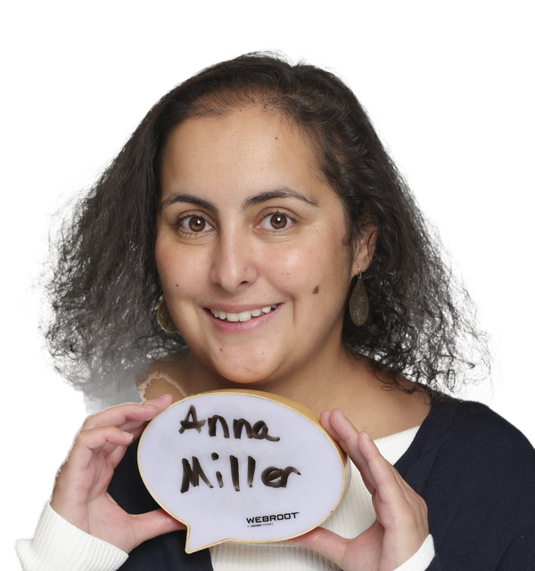 Anna Miller holding a speech-bubble cookie with her name written on it.